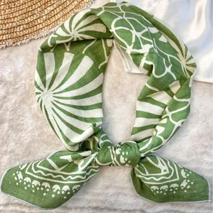 Elegant green cotton square scarf with white pastoral geometric patterns tied in a knot