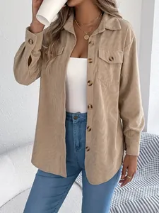 Detailed shot of a beige corduroy oversized shirt with button-down front and pockets.