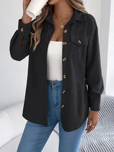 Close-up detail of women's black corduroy long sleeve shirt jacket with buttons