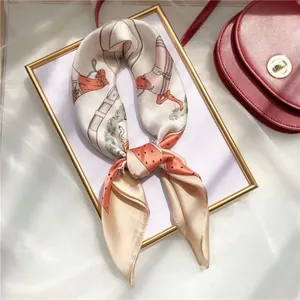 Detailed view of an equestrian-printed silk square scarf on a display frame