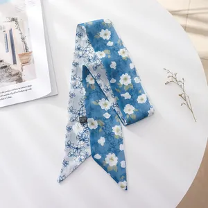 Detailed view of a French retro blue floral chiffon skinny scarf for hair styling.