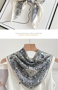 Macro detail of elegant blue and white paisley pattern silk scarf for women's fashion