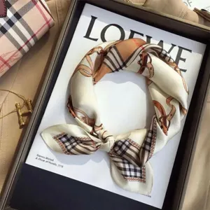 Close-up of elegant square silk scarf featuring luxury belt pattern and plaid accents