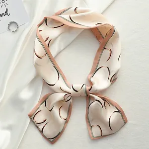Detail view of a French style skinny silk scarf with elegant heart patterns
