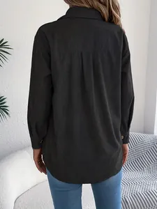 Back view of a loose-fit dark green corduroy shirt featuring a textured vertical rib pattern