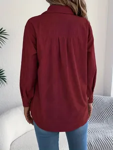 Back view of elegant burgundy corduroy long-sleeve oversized shirt with pleat detail.