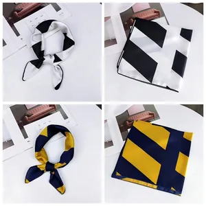 Detailed view of small silk scarves with geometric patterns in black and yellow colorways.