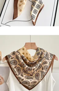 Elegant paisley and polka dot silk-like scarf shown in a detailed close-up and on a hanger
