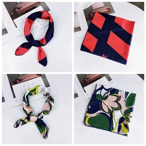 Detailed view of small printed square silk scarves featuring geometric and floral patterns