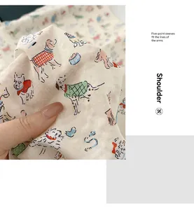 Detailed macro shot of soft cotton linen square scarf featuring colorful cartoon dog prints.
