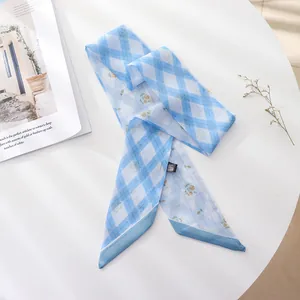 Detail view of a French vintage blue floral chiffon hair ribbon scarf on a table.