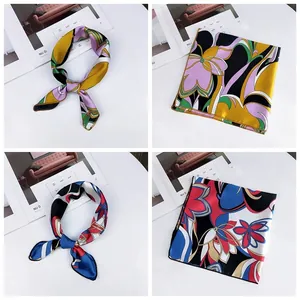 Detail view of premium floral printed square silk scarves in vibrant colors and patterns