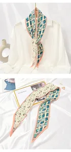 Detailed view of a pleated skinny scarf with mixed floral and geometric patterns on white satin.