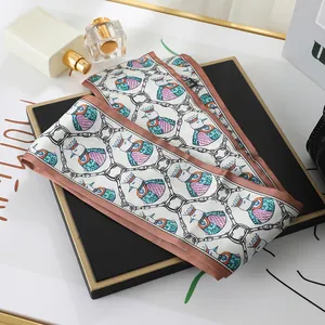Detailed view of an elegant double-layered satin scarf with bird and chain link patterns