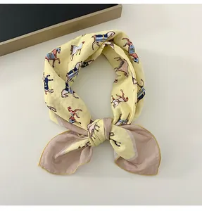 Detail of yellow cotton linen scarf featuring colorful horse pattern illustrations