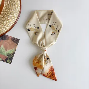Detailed view of narrow silk scarf with elegant crane oil painting pattern on white