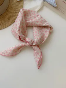 Close-up of a pink floral cotton linen square scarf with vintage aesthetic