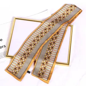 Close-up detail of vintage floral pattern on long silk-like French hair ribbon scarf