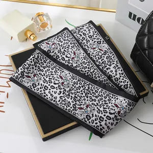 Close-up of leopard print chiffon scarf with artistic cat eye patterns