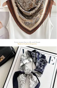 Elegant blue and white paisley silk-like scarf shown with a VOGUE magazine.
