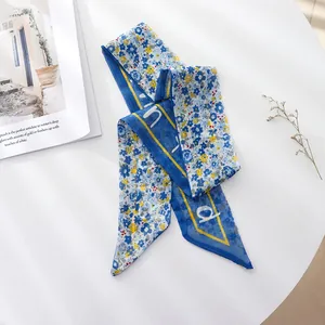 Close-up of blue floral chiffon hair ribbon showing the retro French style and soft texture