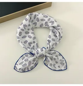 Detail of white cotton linen square scarf with delicate blue leaf and berry print