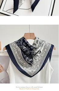 Elegant blue and white paisley silk-like scarf draped on a hanger for a fashion detail view.