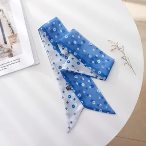 Close-up view of a delicate blue floral chiffon hair scarf with French vintage floral pattern