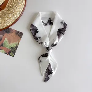 Close-up detail of a white narrow silk hair band featuring a black landscape ink painting