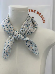 Close-up detail of a soft cotton linen floral paisley scarf tied as a vintage neckerchief