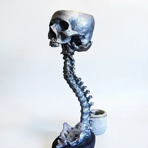 Realistic silver metallic skull planter with curved spine stand gothic home decor
