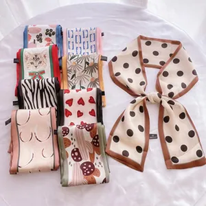 Collection of narrow vintage silk scarves with various patterns on white fabric