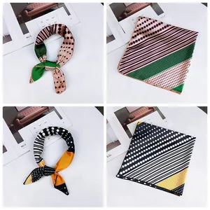 Macro view of elegant square silk scarves with polka dots and stripes patterns.