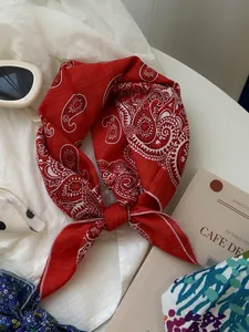 Detailed view of a soft red paisley pattern cotton linen square neckerchief scarf