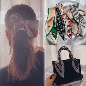 Detail of French vintage silk scarf ribbons used as hair tie and bag accessory.