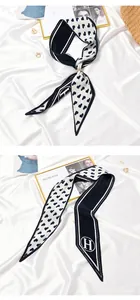 Pleated narrow silk scarf with heart print and H logo detail on white satin.