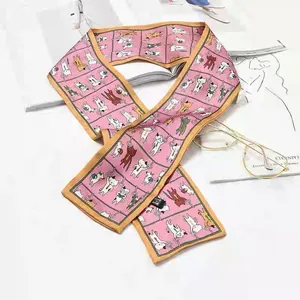 Macro view of a pink French retro silk scarf featuring playful cartoon cat patterns.