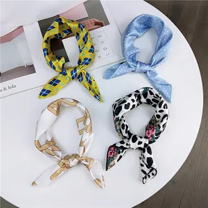 Set of four stylish printed small silk square scarves with various decorative patterns