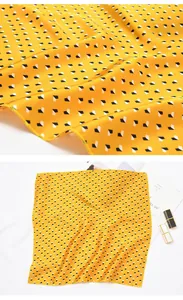 Detailansicht gelbes quadratisches Halstuch mit geometrischem Würfelmuster und Textur