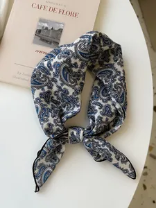 Close-up of a vintage paisley pattern cotton linen square scarf knotted as a necktie