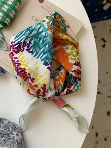 Close-up of vibrant colorful floral print on a vintage style cotton linen square scarf