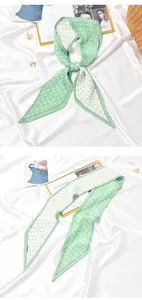 Detailed view of a green pleated silk neck scarf featuring a white polka dot pattern design