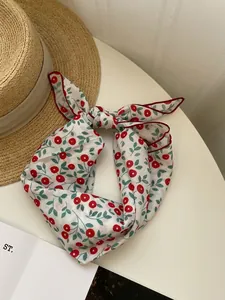 Close-up detail of vintage floral cherry print cotton linen scarf with soft texture