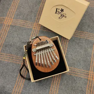 Handheld 8-key solid wood mini kalimba thumb piano in a kraft gift box, detail view