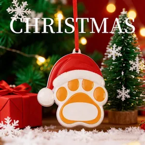 Close-up of a dog paw Christmas ornament with a Santa hat and DIY name space.