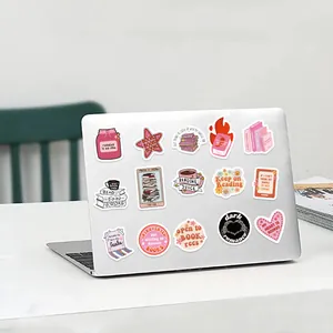 Detail view of pink Bookish stickers applied to a silver laptop cover for decoration