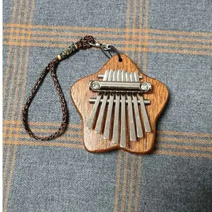 Detailed macro shot of an 8-key mini wooden kalimba thumb piano with floral star shape design