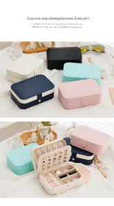 Detailed view of portable jewelry storage box showing interior compartments for rings and earrings.