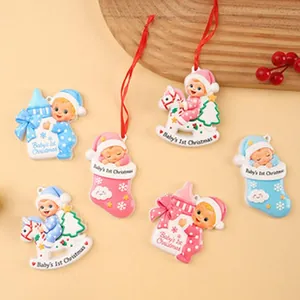 Detailed view of Baby's 1st Christmas resin hanging ornaments in pink and blue colors.