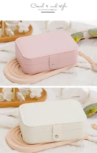 Detailed view of portable double-layer jewelry organizer boxes in pink and beige colors